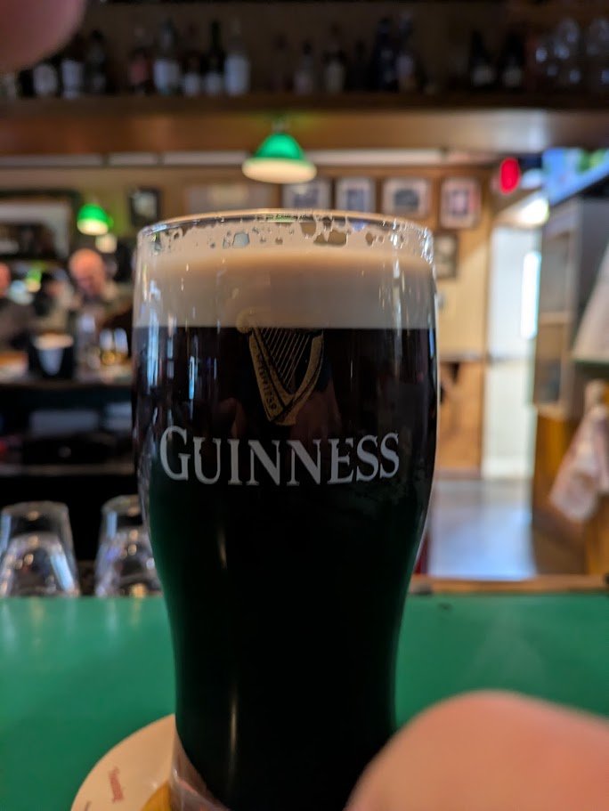 Cozy Irish pub interior with dark wood tables.