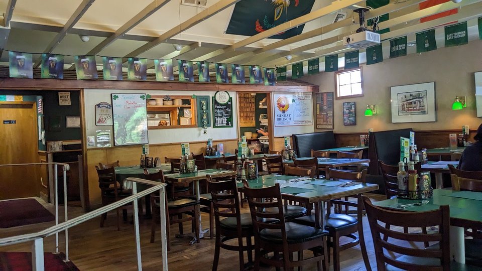 Bar seating and warm lighting inside the pub.